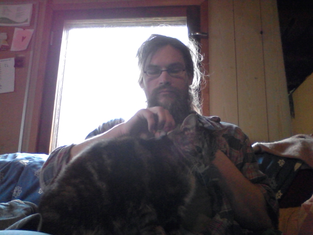 Mending my jeans. The cat wants to help.