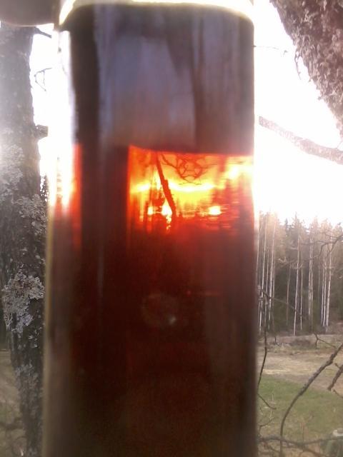 sunset seen through a bottle of brandy